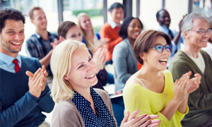 A group of middle aged men and women smiling happily