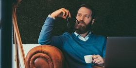 A man looks thoughtfully off into the distance 