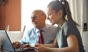 Two people using a laptop