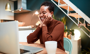 Person laughing at their laptop