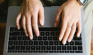 Person typing on laptop