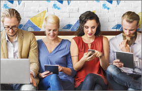 4 people looking at computers and mobile devices