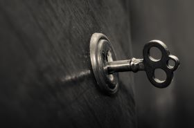 A silver key shown in a lock